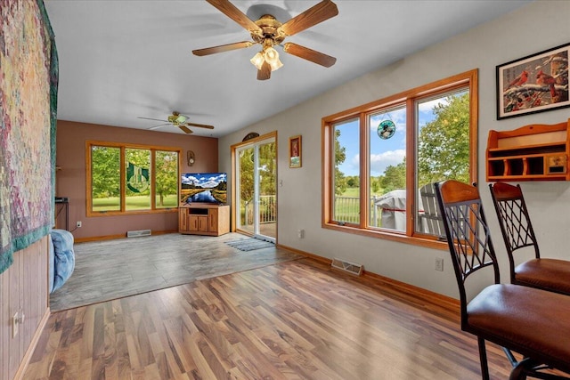 interior space featuring wood finished floors, visible vents, and baseboards