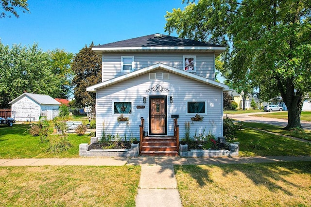 view of front of property featuring an outdoor structure and a front yard