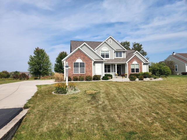 view of front of property featuring covered porch and a front yard