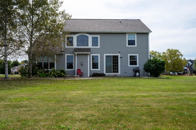 rear view of property with a lawn