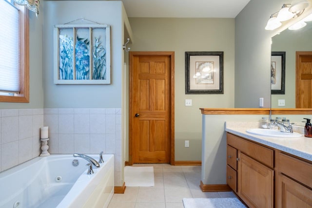 bathroom with vanity, tile patterned flooring, and tiled bath