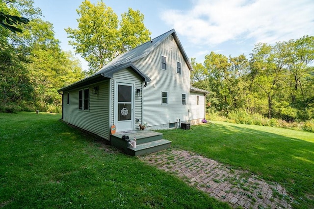 exterior space featuring a lawn and central AC unit