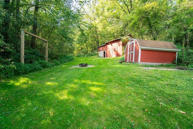 view of yard with a fire pit and a shed