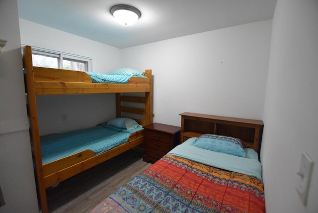 bedroom with dark hardwood / wood-style flooring