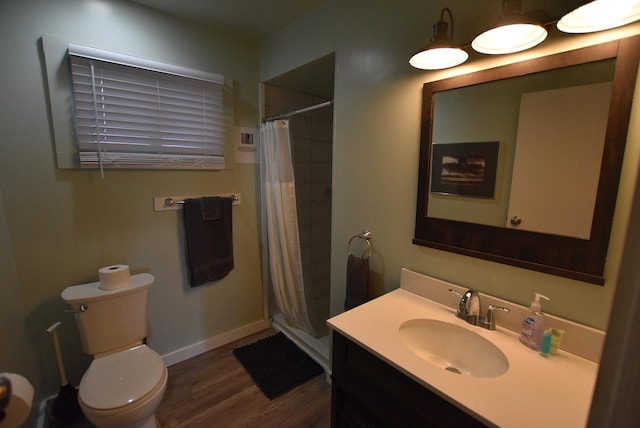 bathroom featuring vanity, toilet, a shower with curtain, and hardwood / wood-style floors