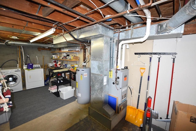 basement featuring washing machine and clothes dryer and water heater