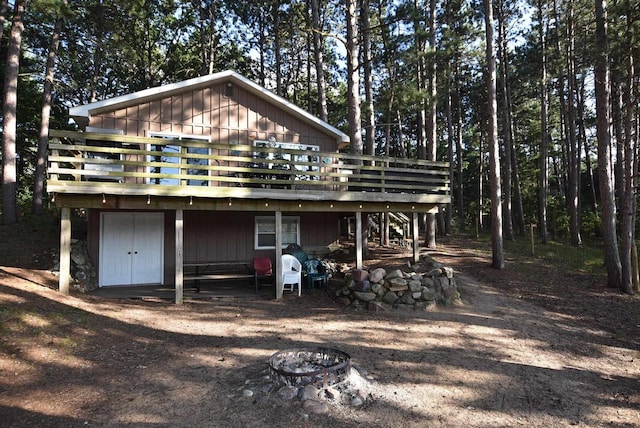 exterior space featuring an outdoor fire pit and a deck