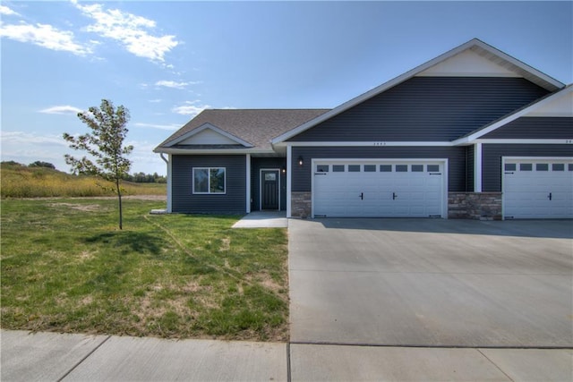 view of front of home featuring a garage and a front lawn