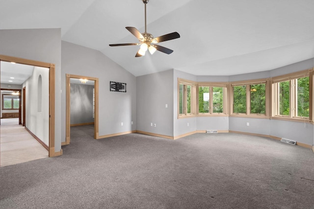 unfurnished room with light carpet, vaulted ceiling, plenty of natural light, and ceiling fan