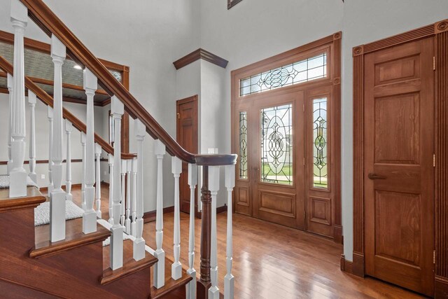 spare room featuring ornamental molding, hardwood / wood-style flooring, and a chandelier