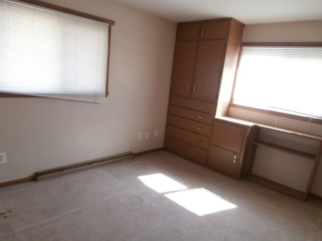 unfurnished bedroom with baseboards and light carpet