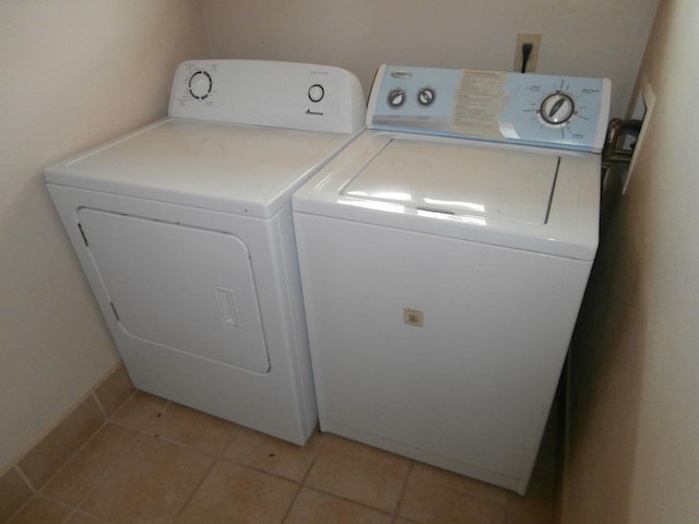 laundry room featuring light tile patterned floors, washing machine and dryer, and laundry area