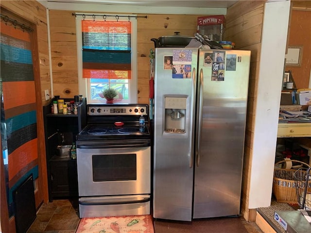 kitchen featuring wood walls and appliances with stainless steel finishes