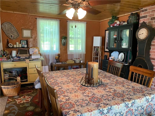 dining space with wood ceiling, a wood stove, dark colored carpet, and ceiling fan