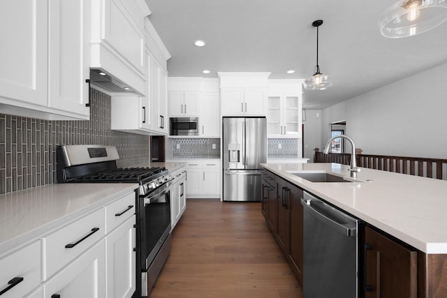 kitchen featuring appliances with stainless steel finishes, sink, white cabinets, and dark wood-type flooring