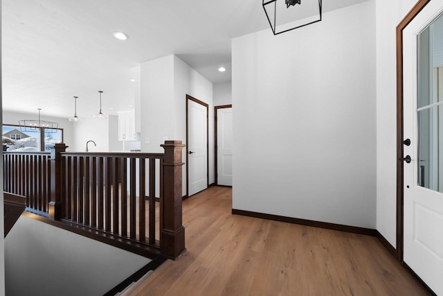 hallway featuring wood-type flooring and sink