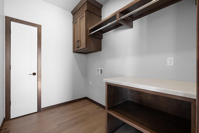 washroom with cabinets, hardwood / wood-style floors, and washer hookup