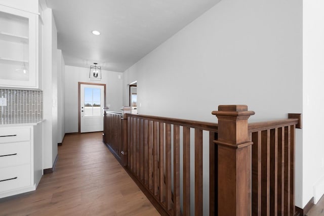 corridor with dark hardwood / wood-style flooring