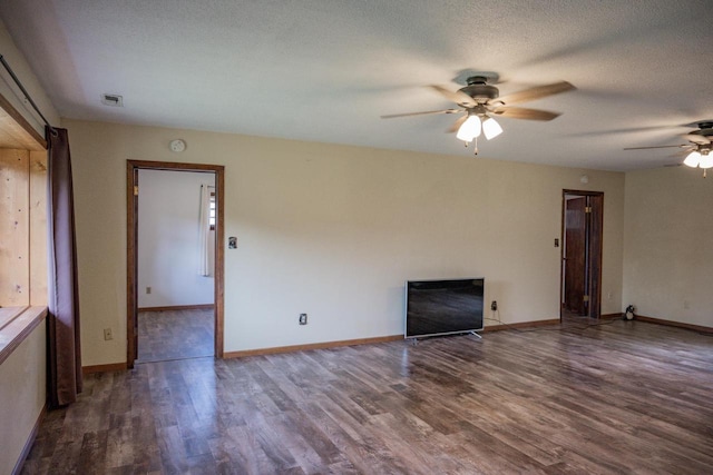 unfurnished living room with ceiling fan, dark hardwood / wood-style flooring, and a textured ceiling