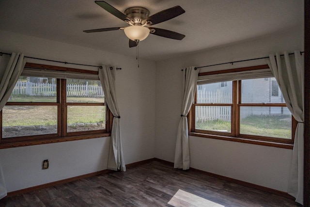 unfurnished room with ceiling fan and dark hardwood / wood-style flooring