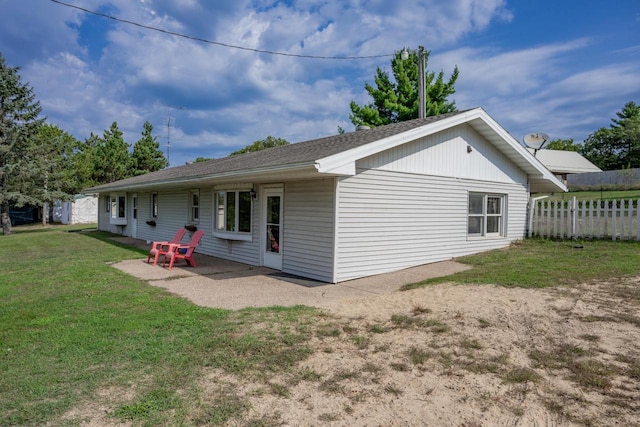 rear view of property featuring a yard and a patio