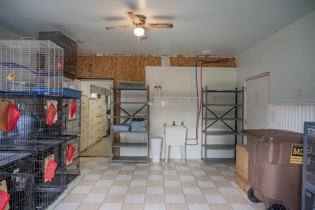 interior space with ceiling fan and sink