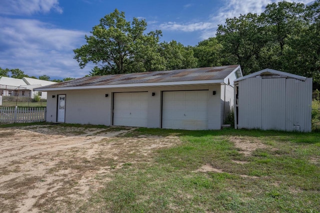 garage featuring a lawn