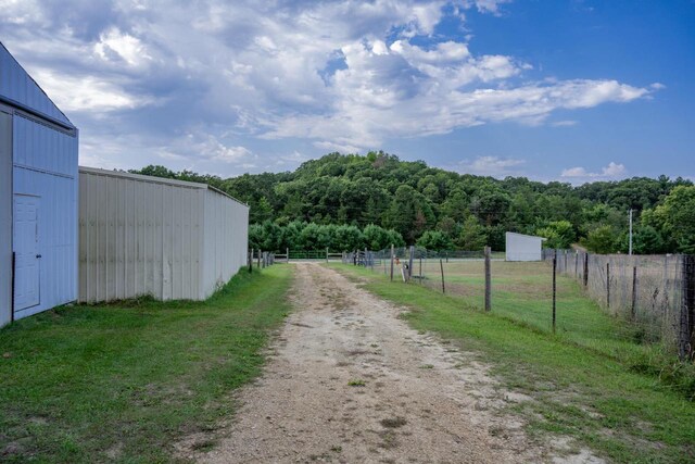 exterior space featuring an outbuilding and a rural view