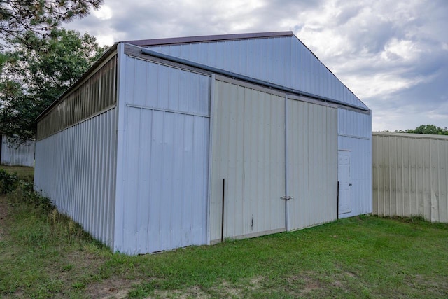 view of outbuilding featuring a lawn