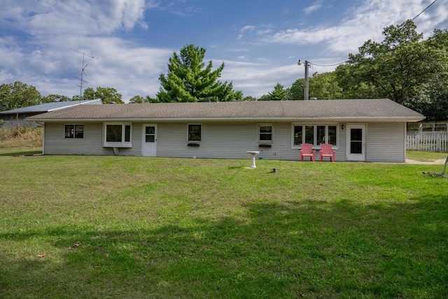 rear view of house with a lawn