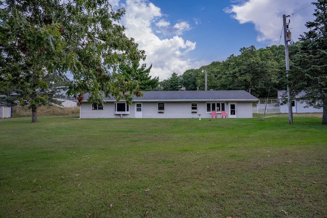 rear view of property featuring a yard