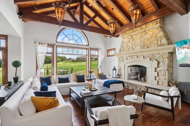 living room featuring beamed ceiling, an inviting chandelier, dark hardwood / wood-style floors, wooden ceiling, and a stone fireplace