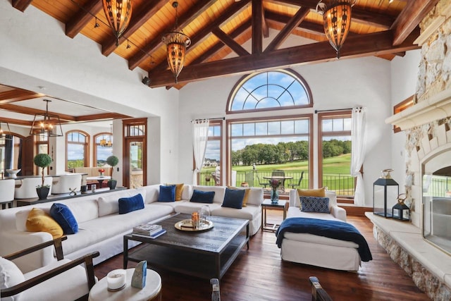 living room featuring dark wood-type flooring, a wealth of natural light, an inviting chandelier, and wooden ceiling