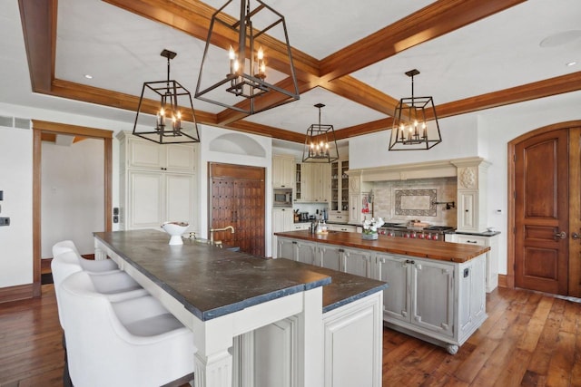 kitchen with dark hardwood / wood-style floors, hanging light fixtures, and a large island