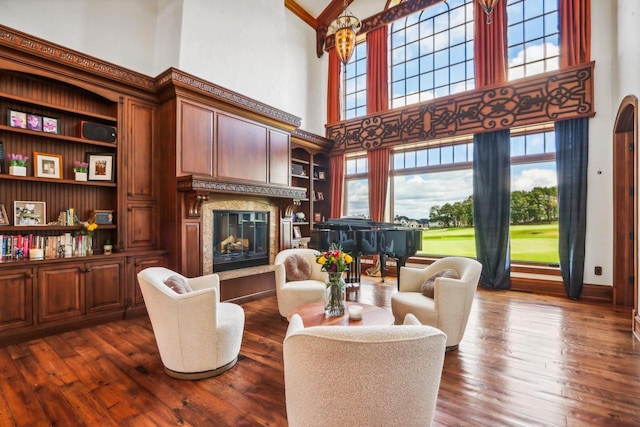 living room with dark hardwood / wood-style flooring and a towering ceiling