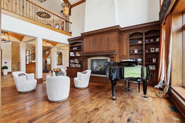 interior space with a high ceiling, hardwood / wood-style floors, and a chandelier