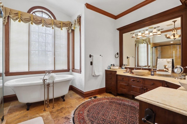 bathroom featuring ornamental molding, vanity, a bath, and vaulted ceiling