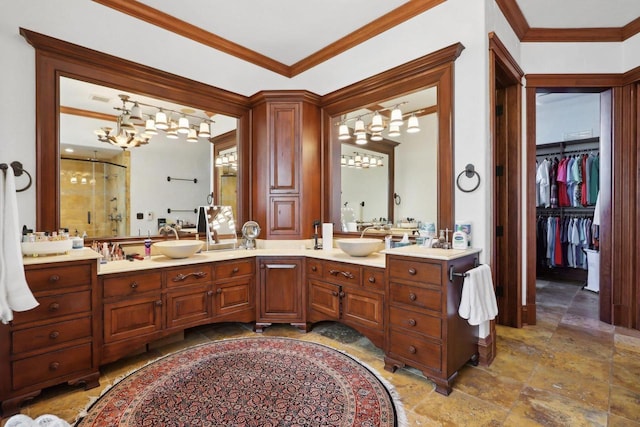 bathroom with crown molding, vanity, and walk in shower