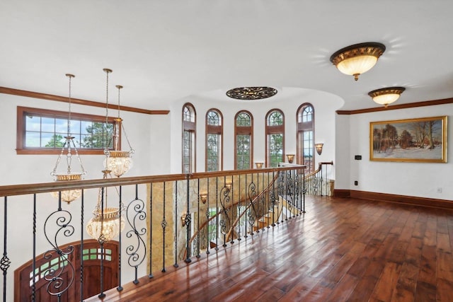 hallway featuring dark hardwood / wood-style floors and an inviting chandelier