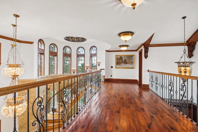 hall featuring dark wood-type flooring and a chandelier