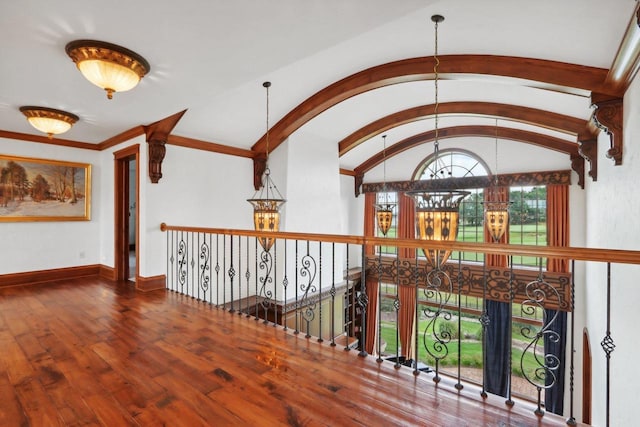 hall featuring lofted ceiling and hardwood / wood-style flooring