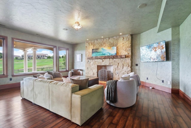 living room with a fireplace and dark wood-type flooring