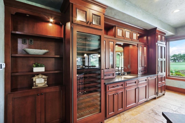 bar featuring a textured ceiling and sink