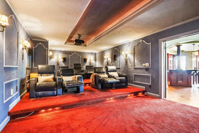 carpeted home theater room with ornamental molding and ornate columns