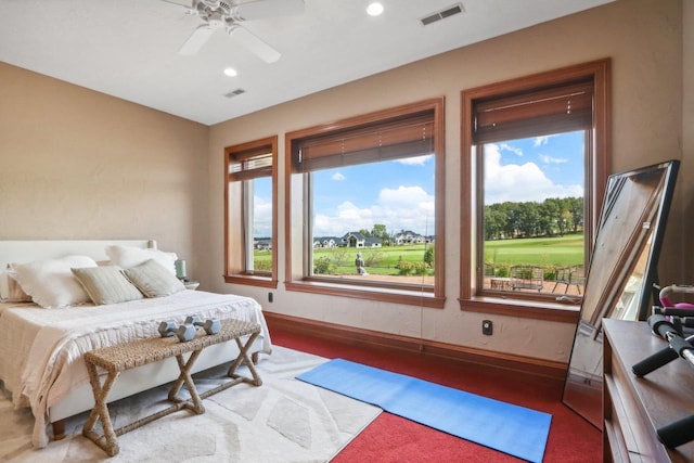 bedroom with multiple windows and ceiling fan