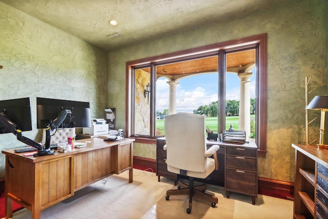 office area featuring light wood-type flooring and ornate columns