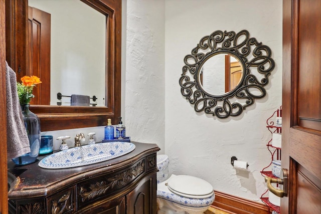 bathroom featuring toilet and vanity