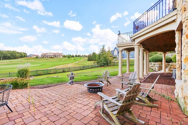 view of patio / terrace with a balcony and an outdoor fire pit