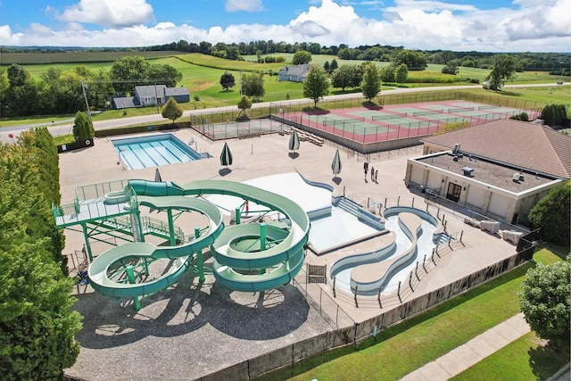 view of swimming pool with a patio area and a lawn