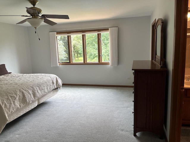 carpeted bedroom featuring connected bathroom and ceiling fan